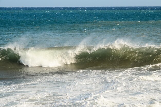 Big blue wave breaks in the atlantic ocean