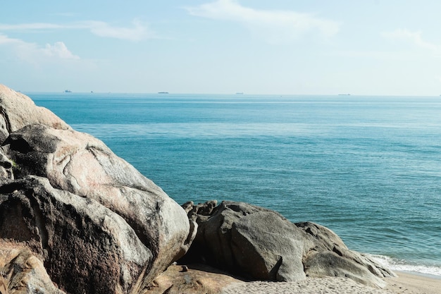 Big boulders on the beach and beautiful sky backdrop