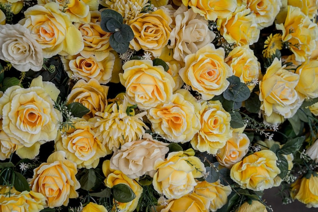 Big bouquet of flowers in a vase on a gray wall background