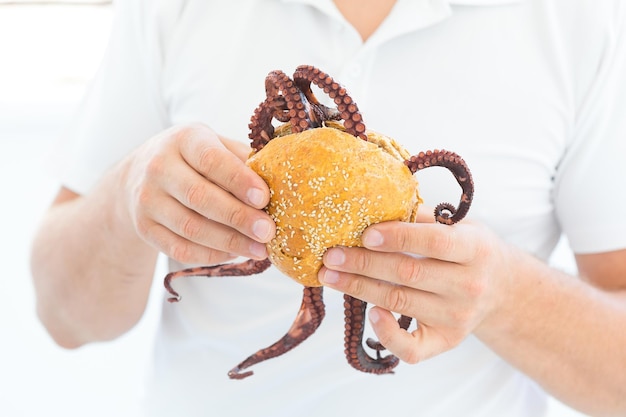 Big burger with octopus ,Large sandwich stuffed with seafood Healthy fast food concept