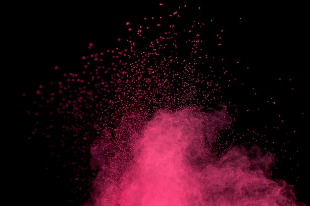 Photo big burst of pink cosmetic powder on dark background
