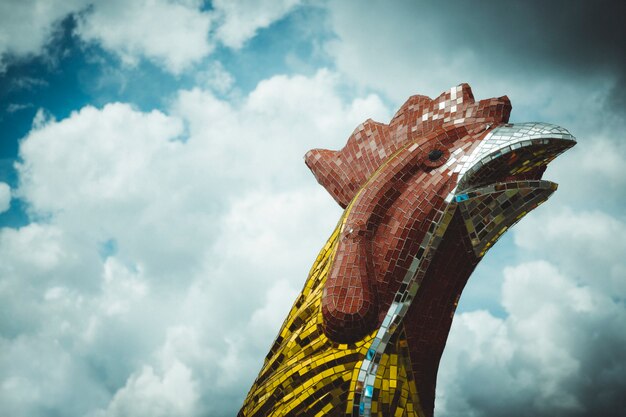 Big chicken head  statue  on blue sky background