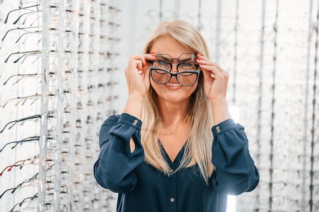 Big choice of glasses Woman is in the store