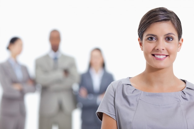 Big Close up of a businesswoman smiling and a team in background