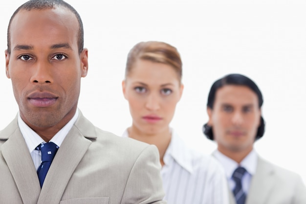 Big close-up of serious people dressed in suits in a single line