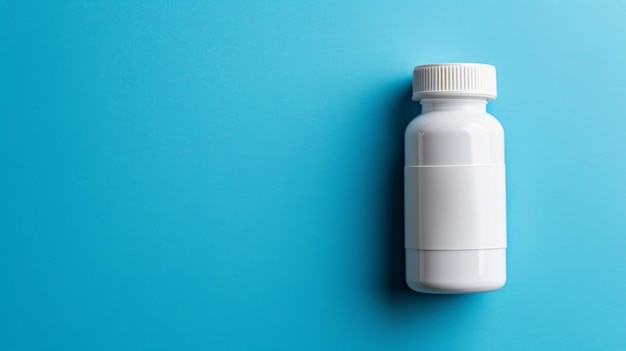 A big copy space with a blank white pill bottle on blue background top