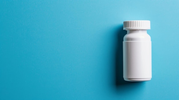 A big copy space with a blank white pill bottle on blue background top