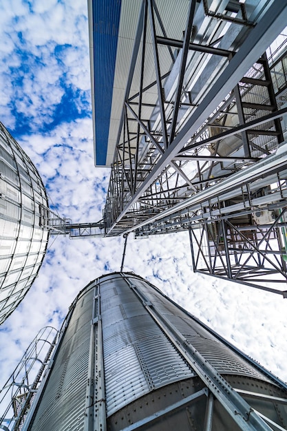 Big cylindrical storage on blue sky Great construction of warehouse Metallic agricultural building