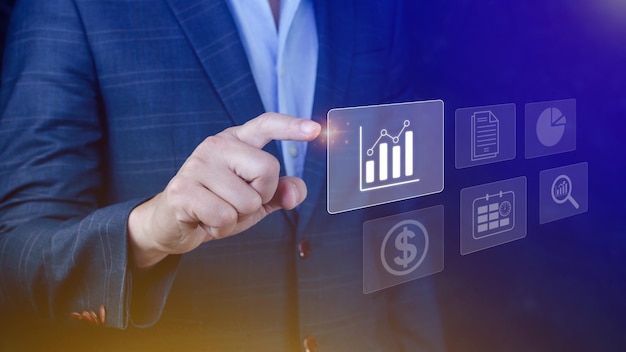 Big data analytics and business intelligence BI concept with chart and graph icons on digital screen interface and business people in the background