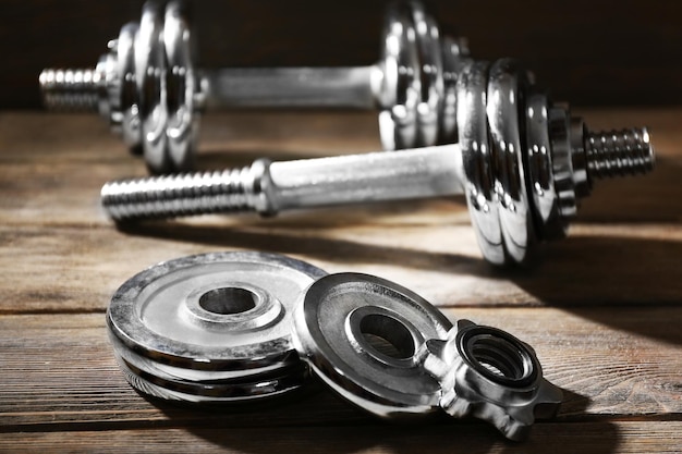 Big dumbbells on wooden background