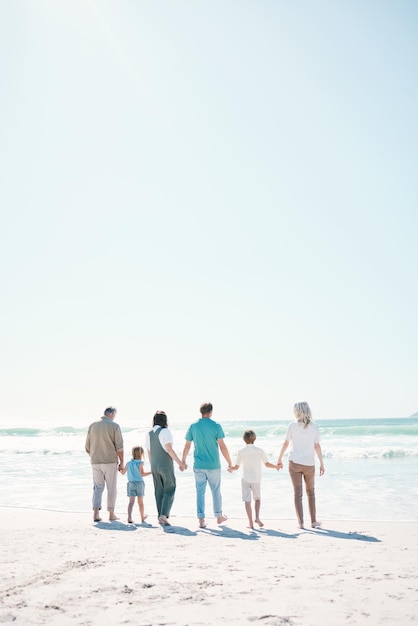 Big family beach and summer vacation on mockup in travel outdoor holiday or together on sunny day Rear view of parents grandparents or kids on ocean coast in fun bonding or break at sea in nature