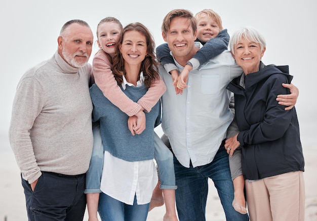 Big family happy and outdoor of a hug with parents grandparents and children with happiness Portrait of mother father and kids with care love and a smile together with senior people hug