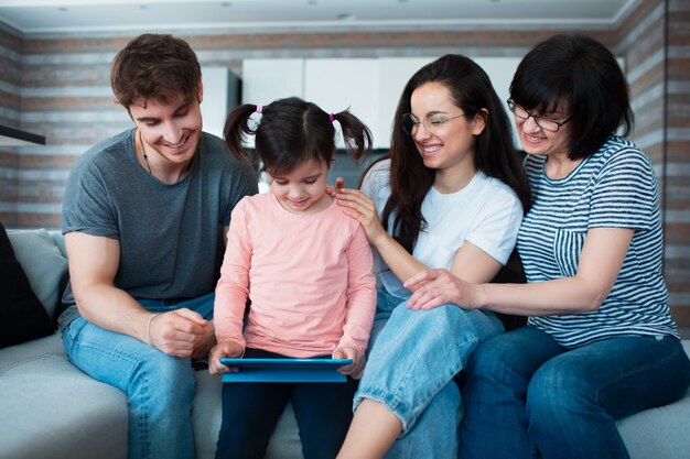 Big family at home. All together communicate online conferences on the tablet.