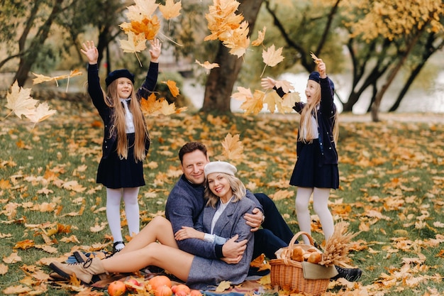 A big family on a picnic in the fall in a nature park Happy people in the autumn park