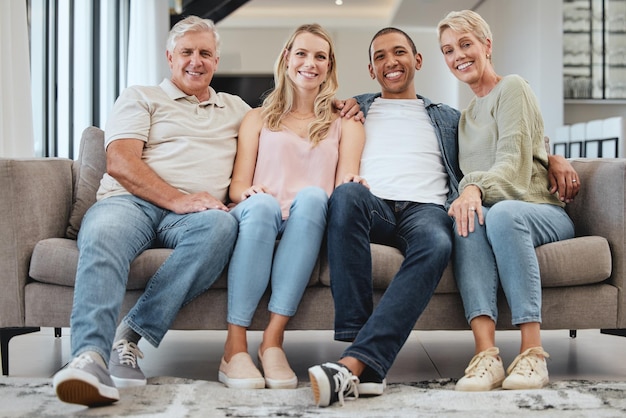 Big family portrait and relax on sofa in home living room smiling and bonding Love care and interracial couple grandmother and grandfather sitting on couch having fun and enjoying time together