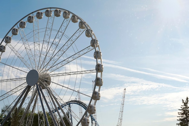 Big Ferris Wheel on clear blue sky background close up