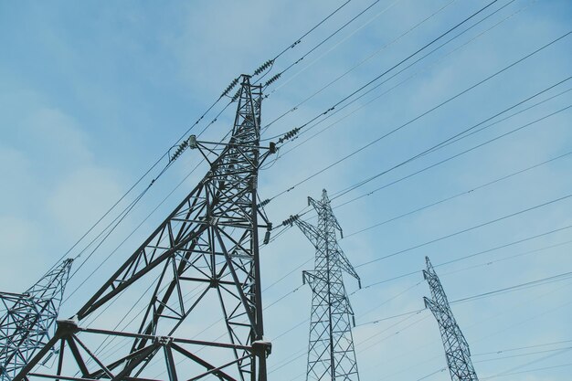 Big frosty power lines among winter snowy park near building Aerial view