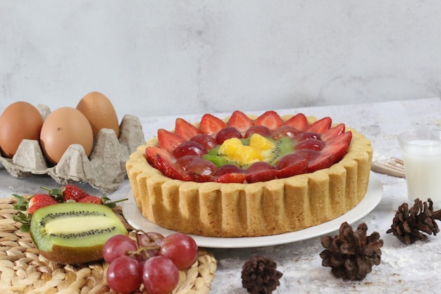 big fruit pie with toppings of strawberries grapes kiwi and pineapple savory sweet and fresh Food concept photo