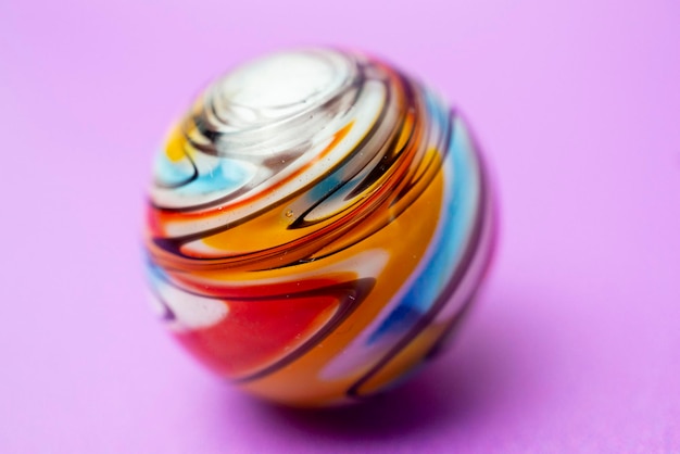 A big glass pearl with a beautiful colorful surface
