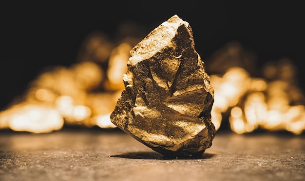 Big gold nugget in front of a mound of gold finance concept