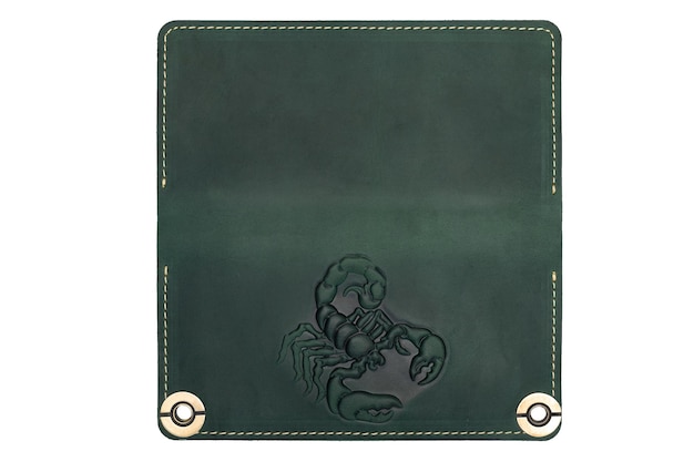 Big green leather wallet on a button on a white background scorpion print Top view