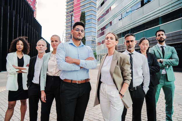 Фото Большая группа успешных бизнесменов стоят вместе на рабочем месте и смотрят в камеру