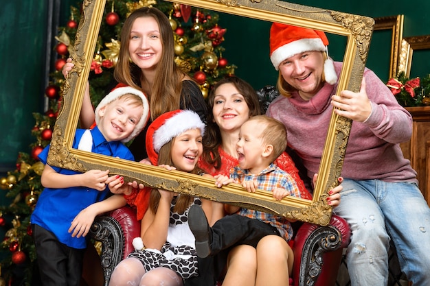 Big happiness smiling family house in santa helper hats