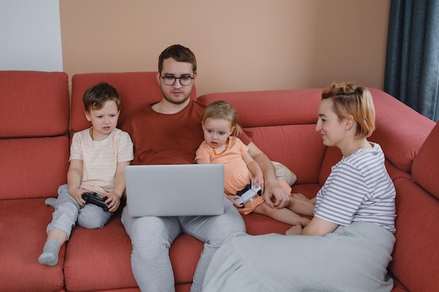 Big happy family with children watching movies playing games on laptop