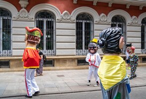 big heads and giants dancing down the street of pontevedra in the festivities of the pilgrim