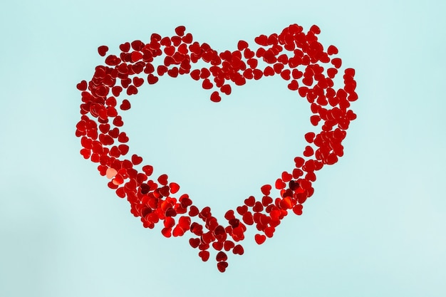 A big heart laid out of small hearts on a blue background, a romantic background