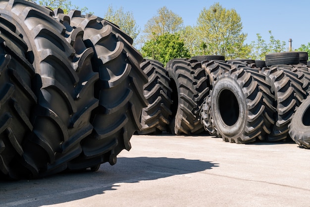 Big machines tires stack. Industrial tires outside for sale