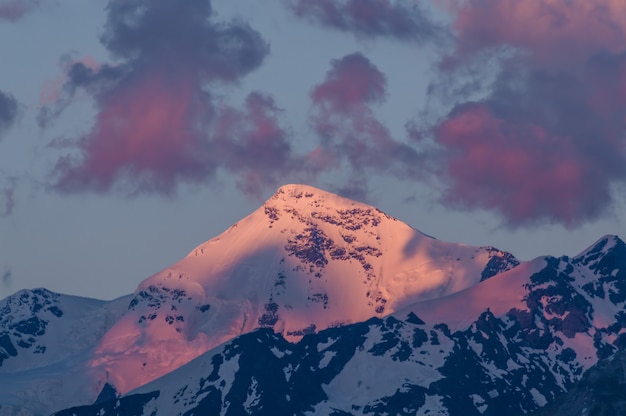 Big mountains in clouds on sunset