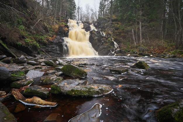 Big picturesque waterfall Jukankoski in the autumn forest Karelia Russia