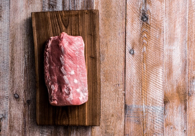 Photo big piece of raw meat on table