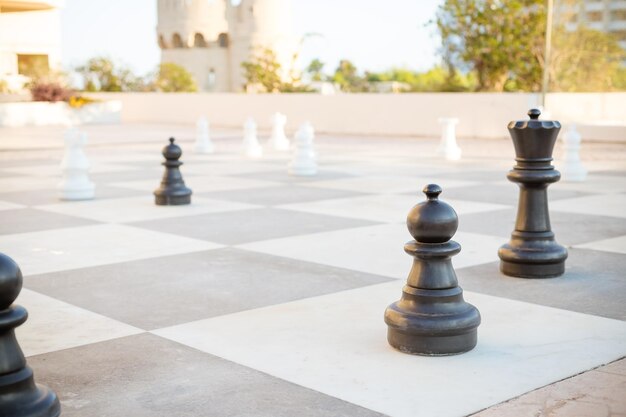 Big pieces chess games in the park street gamesOutdoor oversized chess on the ground in public area zone Selective focus Hobby Leisure and activities