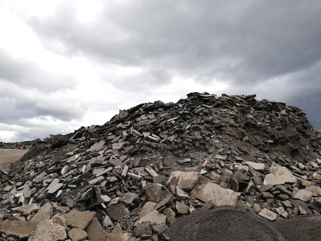 Big pile of construction waste of gray concrete debris