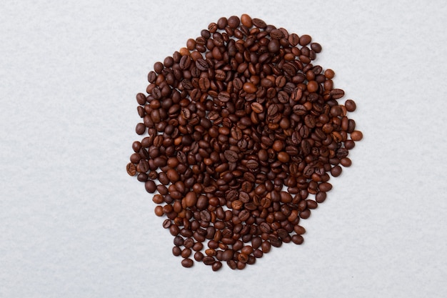 Big pile of roasted coffee beans isolated on white