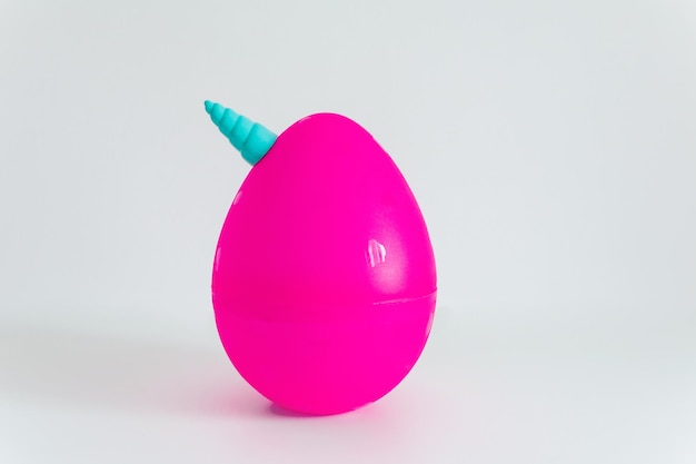 Big pink unicorn egg toy on the white background Popular plastic toy with surprise inside