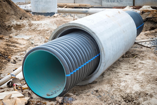 Big pipe or tube for water sewer on construction site during road repair