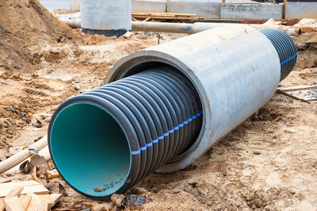 Big pipe or tube for water sewer on construction site during road repair