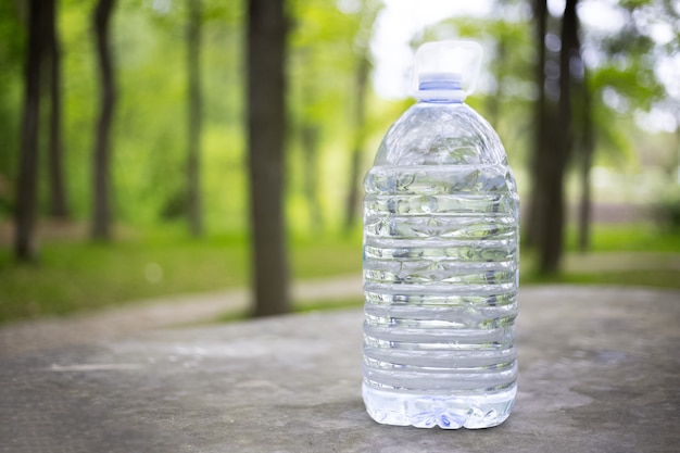 Big plastic bottle with water outdoor.