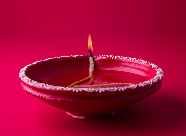 Big red decorative Clay diya or Oil Lamp lit during diwali festival. Selective focus