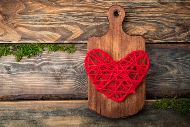 Big red heart on a wooden cutting board