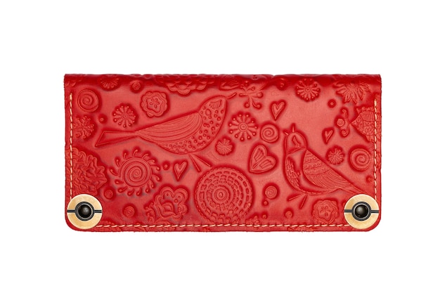 Big red leather wallet on a button on a white background birds print Top view