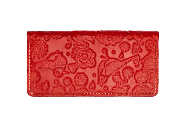 Big red leather wallet on a button on a white background birds print Top view