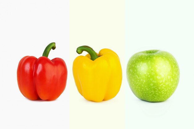 Big red and yellow peppers and big green apple