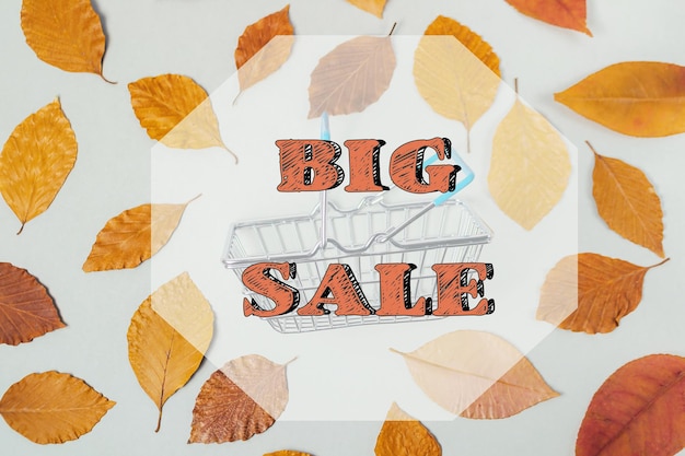 A big sale sign is written on a background of autumn leaves