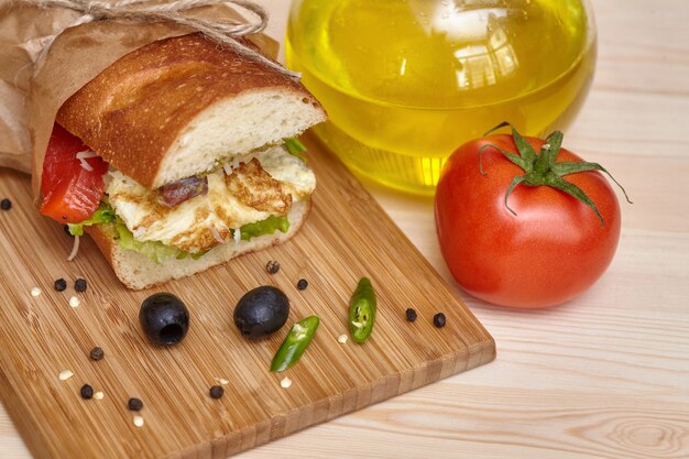 Big sandwich on wooden cutting board