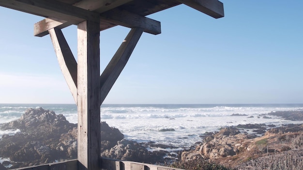 Big sea wave crashing rocky craggy beach california ocean coast gazebo alcove