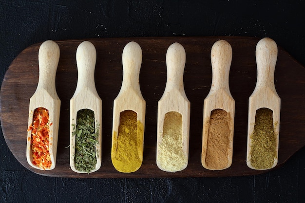 Big set of Indian spices on wooden table Top view Horizontal image